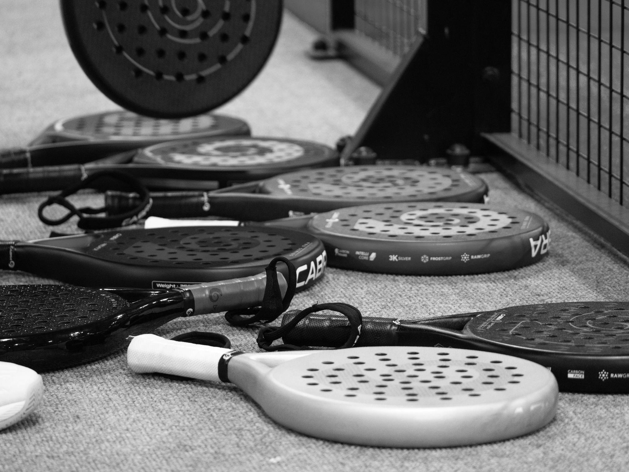 Raquettes de padel alignées, en noir et blanc